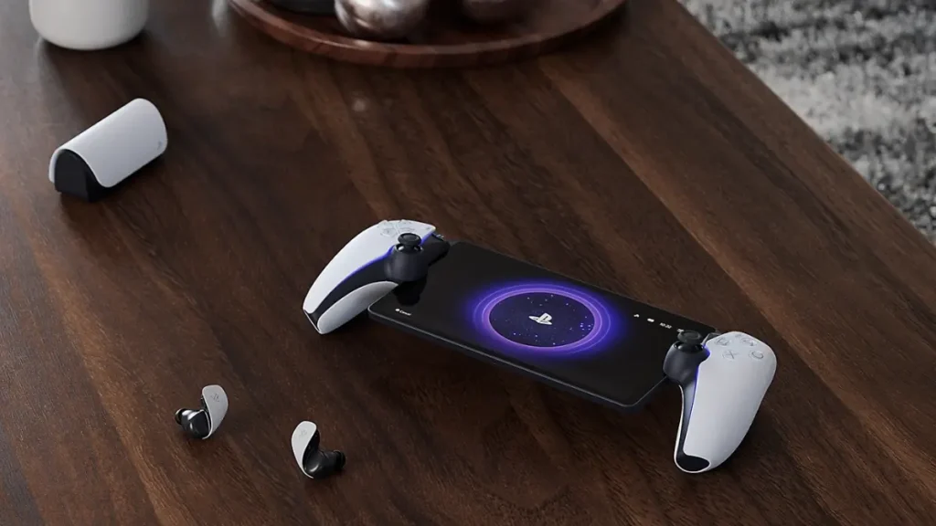 PlayStation Portal placed on a wooden desk next to over-ear headphones, illustrating its standalone design and modern use case