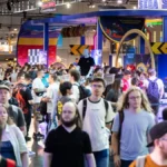 Large crowds gathered at Gamescom 2025 handheld gaming booths with attendees waiting to try Xbox Ally and Nintendo Switch 2 demos