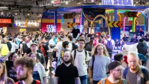 Large crowds gathered at Gamescom 2025 handheld gaming booths with attendees waiting to try Xbox Ally and Nintendo Switch 2 demos