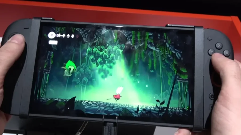 Hollow Knight Silksong gameplay running on Nintendo Switch 2 handheld mode at Gamescom 2025 demo station