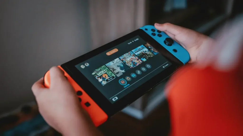 Person enjoying gaming session on Nintendo Switch handheld console