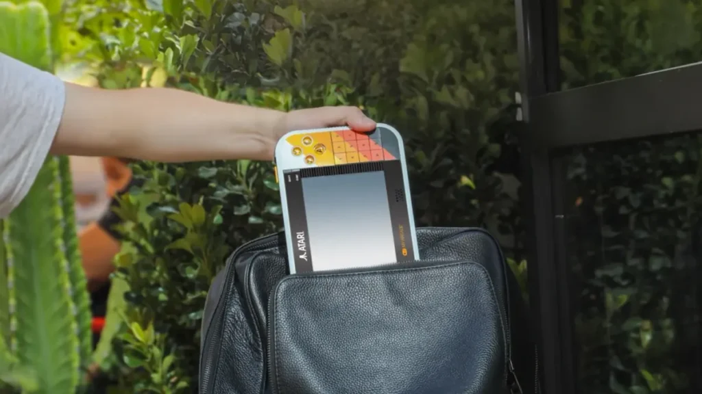 Portable gaming console being stored in leather bag for travel