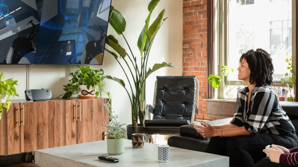 Woman enjoying big screen gaming session in modern living room