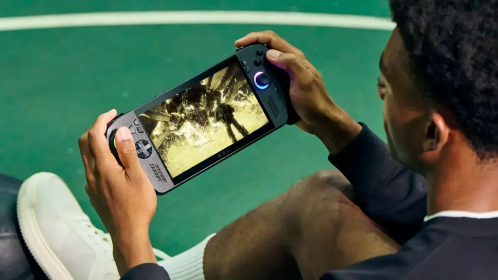 Gamer holding ROG Xbox Ally X handheld console showing ergonomic Xbox controller-inspired grips and 7-inch display